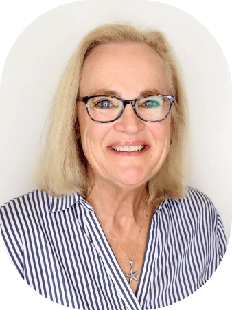 Dr. Marla Jirak smiling in a striped shirt